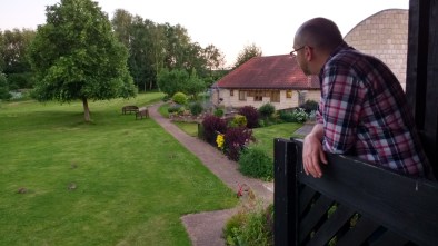 Hubby looking out from a balcony at the grounds of Martin House at several rabbits on the lawn