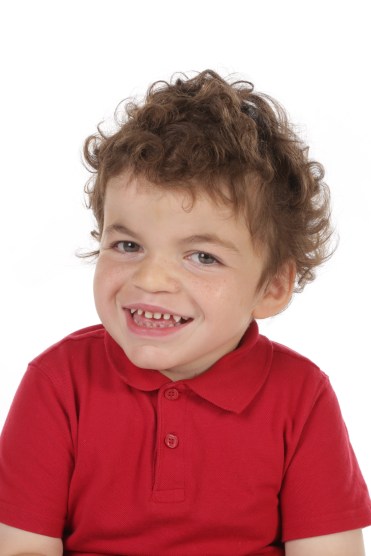 Pudding smiling widely in his red school shirt.