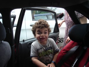 Pudding smiling up at camera before climbing into the car seat.