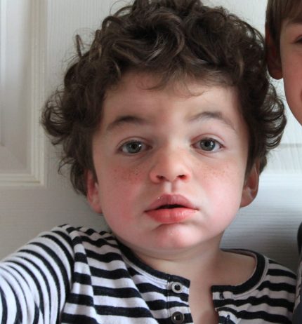 Pudding in a stripey black and white top looking directly at camera, unsmiling.